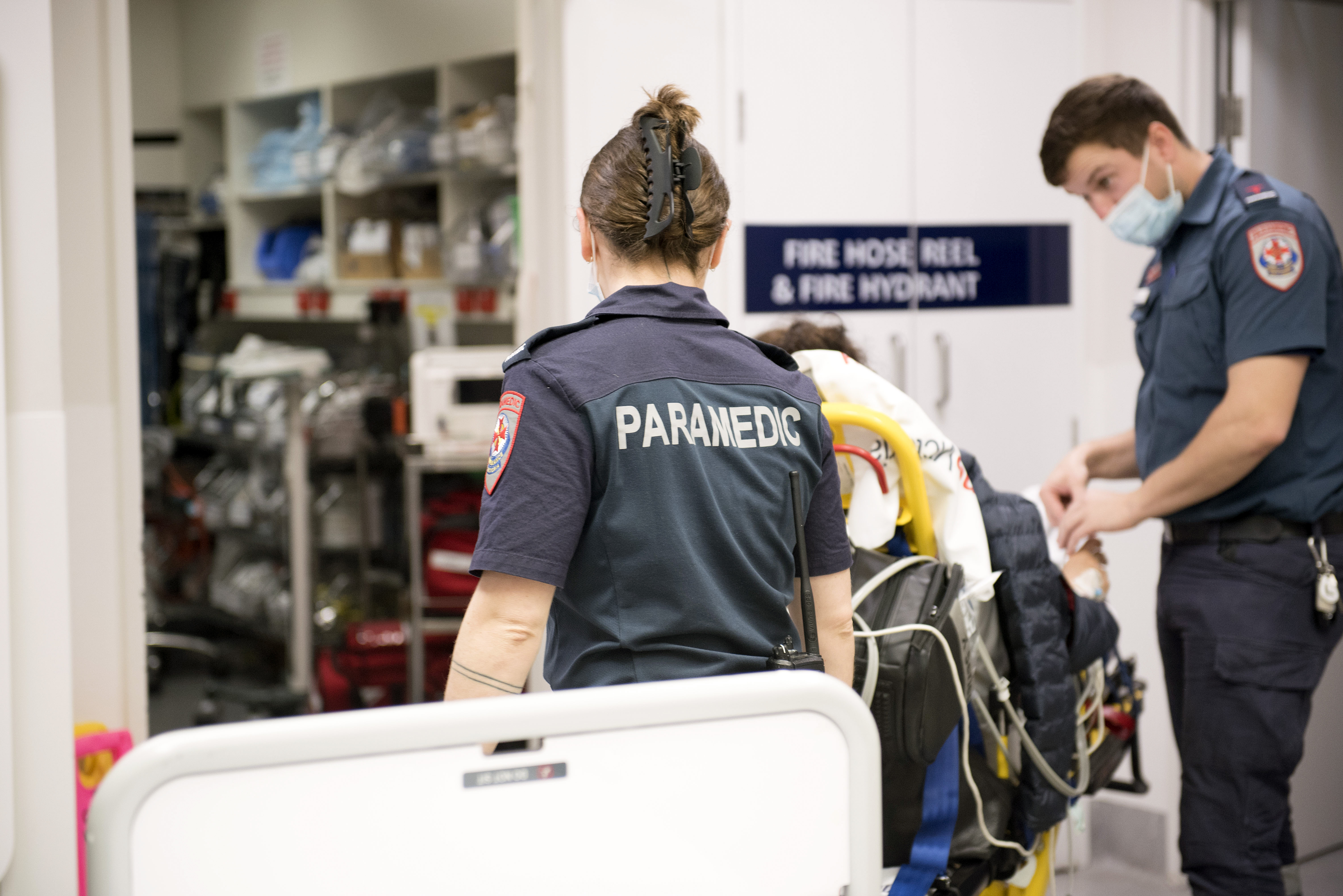 Paramedics talking to a patient on stretcher