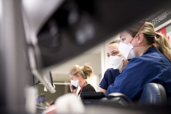 Nurses at front desk wearing masks