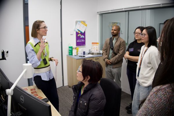 People sitting at a clinician desk as part of a clinical simulation