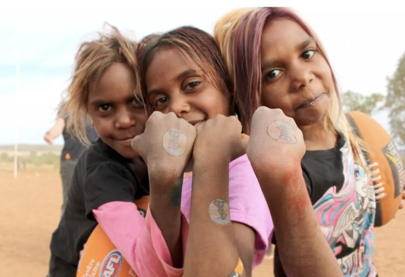 Children from Ntaria in the Northern Territory show off temporary tattoos of ‘Milpa’ the trachoma goanna.
