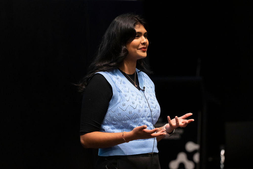 A woman presents to the crowd