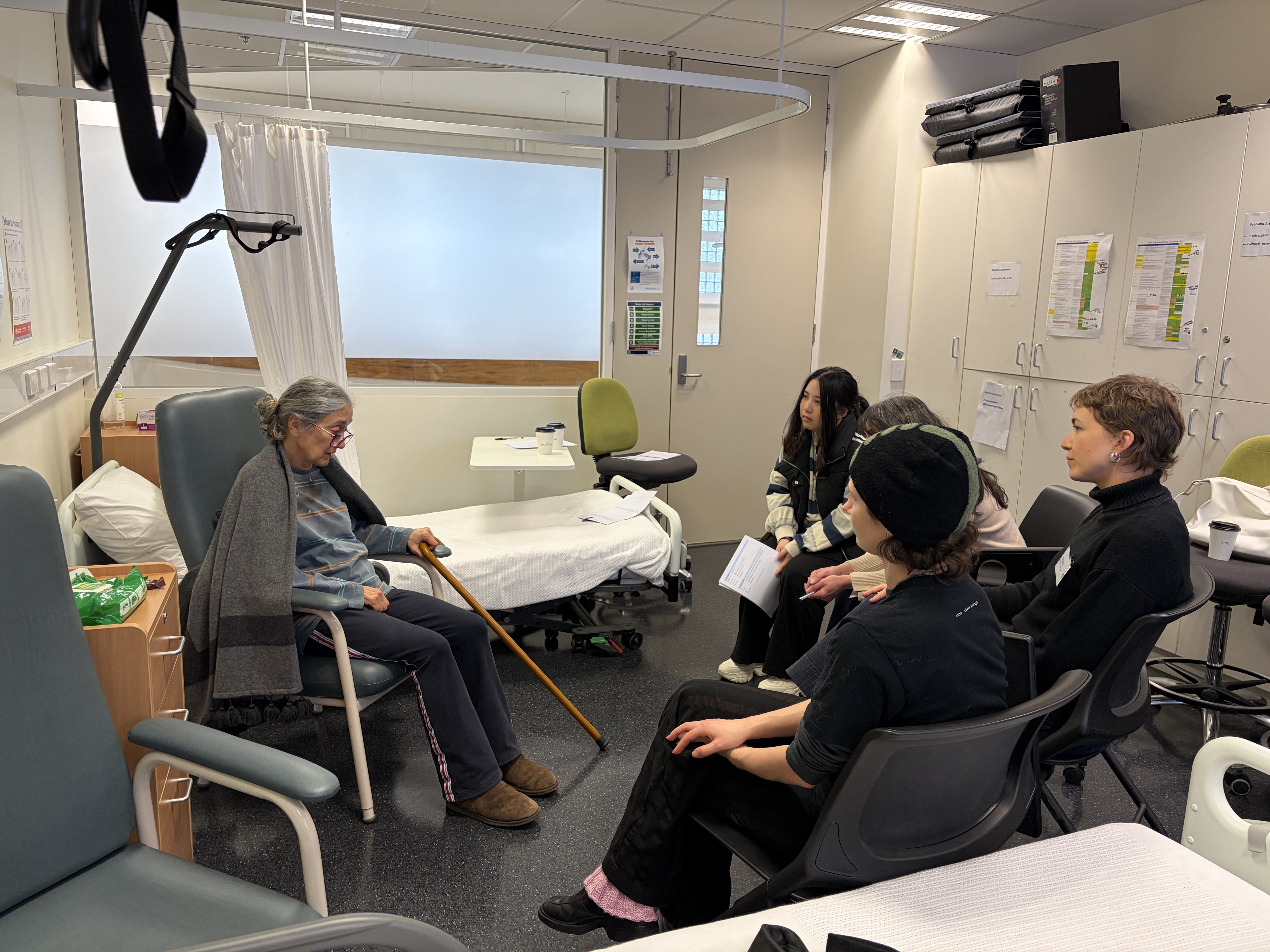 Students engaging with roleplay with senior citizen.