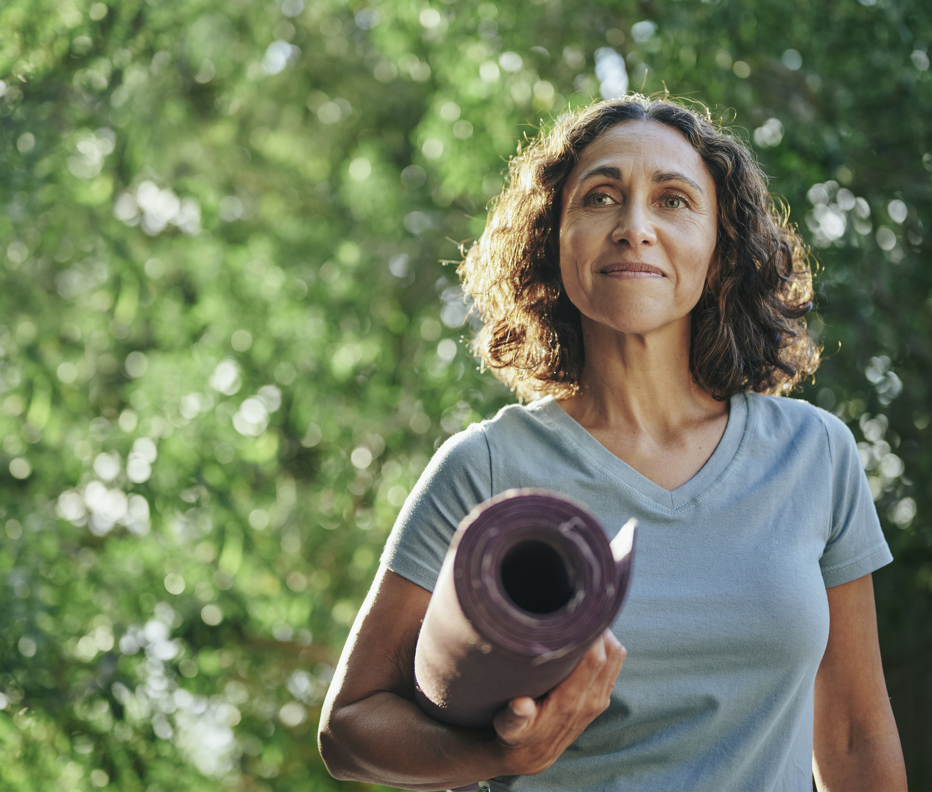 Mature woman with yoga mat