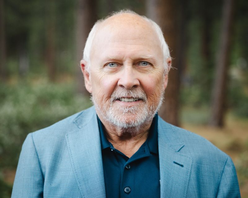 Alum Dr Mick Hitchcock wearing a blue blazer.
