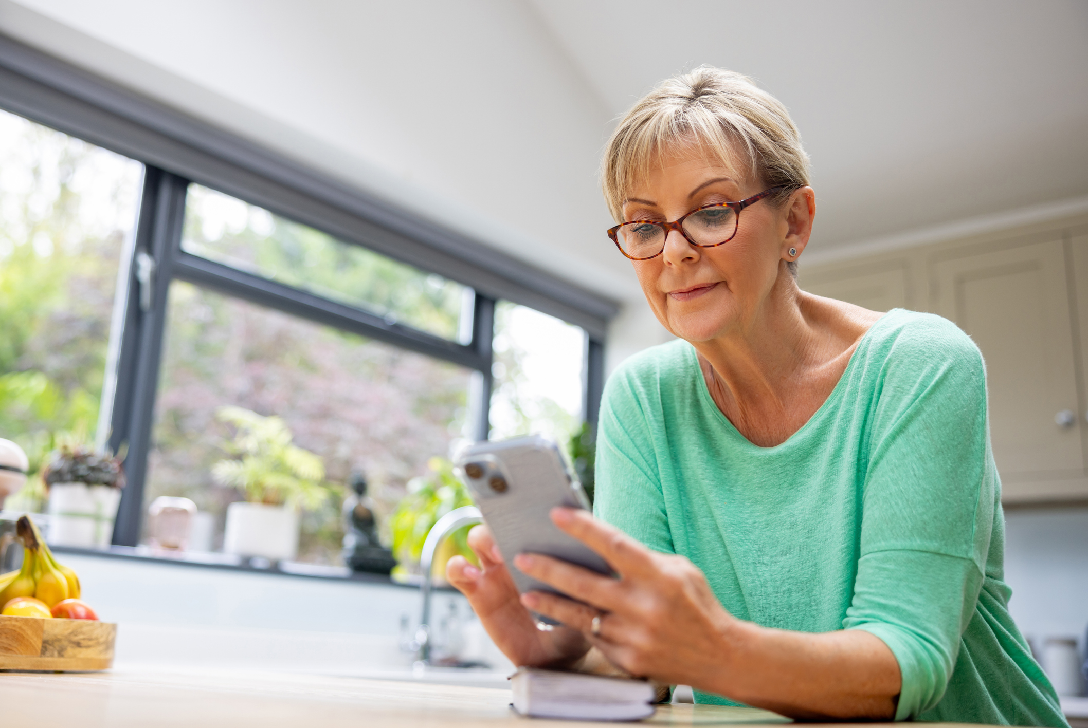A photo of a women holding her phone reviewing it