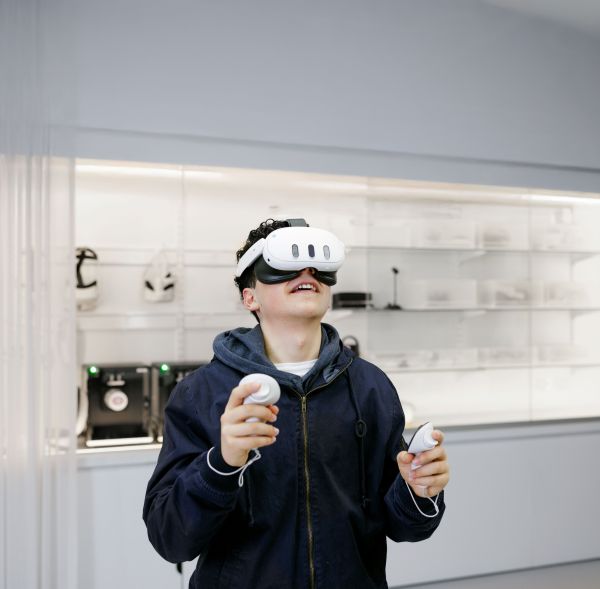 A young person demonstrates the immersive VR lab at Orygen, wearing a VR headset.