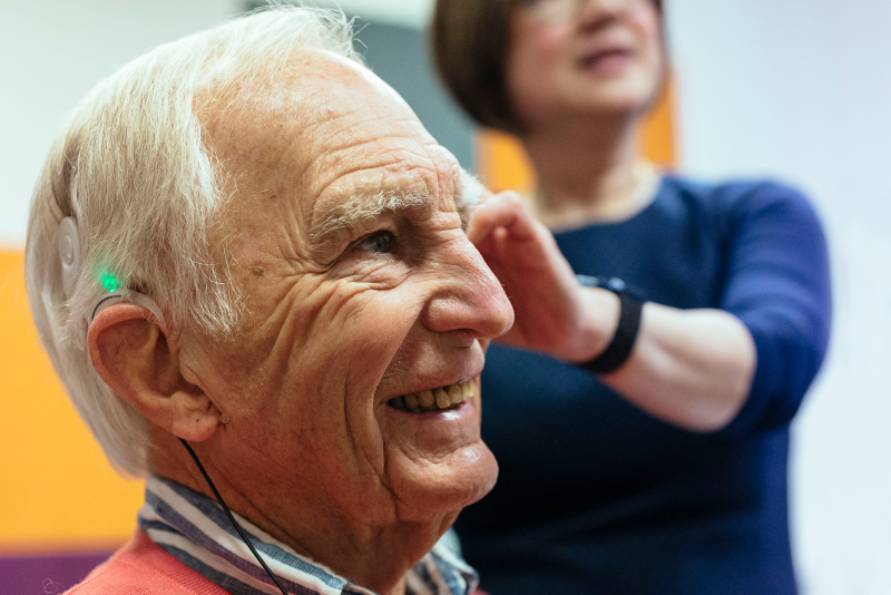Royal Victorian Eye and Ear Hospital patient John Fisher displaying his cochlear implant.
