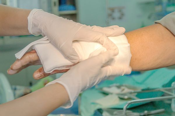 Nurse fits gauze to patient
