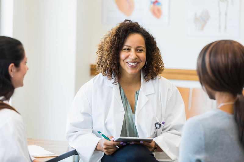 Clinicians with patient and tablet