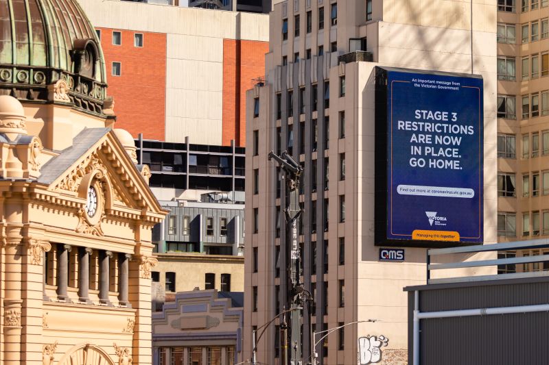 A sign in the Melbourne CBD in 2020 says 'STAGE 3 RESTRICTIONS ARE NOW IN PLACE. GO HOME.'